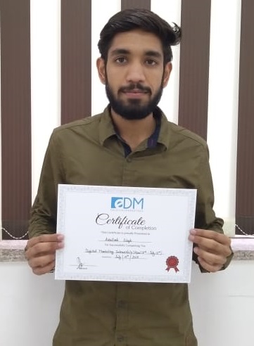 Student holding their E Digital Marketers certificate of completion